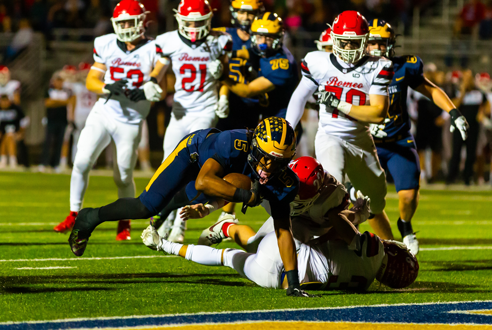 Clarkston's Desman Stephans II dives for the end zone during his team's 33-10 Division 1 playoff win over Romeo.