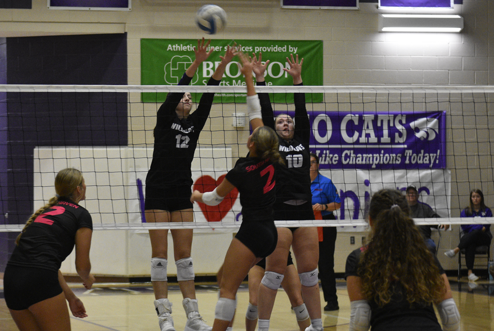 Seniors Jenna Southland (12) and Madelyn O'Hara combine at the net to block a kill attempt by a South Haven player. 