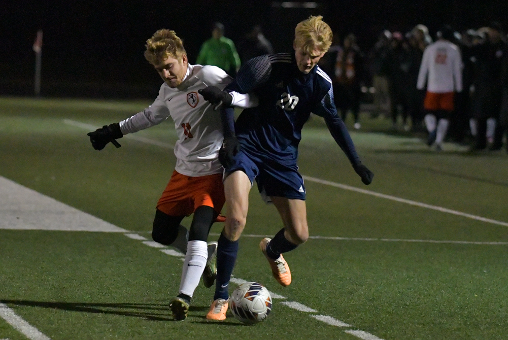 Hudsonville Unity Christian’s Cody Walters (20) works to gain possession during Wednesday’s Division 3 Semifinal win over Alma.