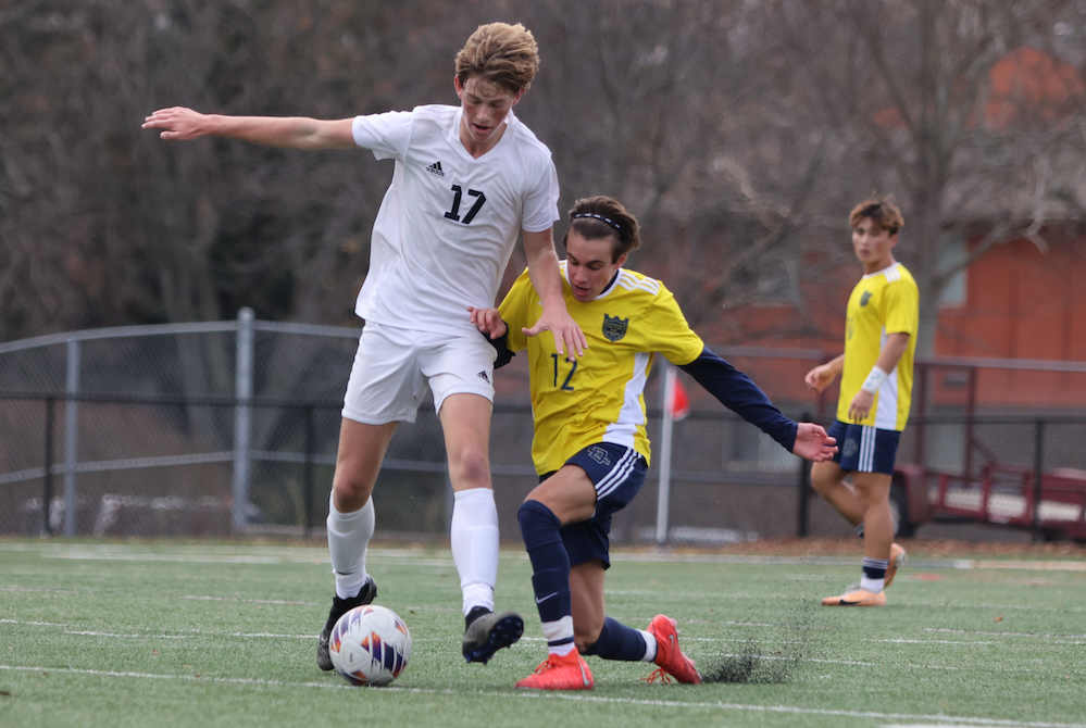 Hudsonville Unity Christian’s Jack Kamminga (17) and Country Day’s Antonio Schimizzi battle for possession Saturday. 