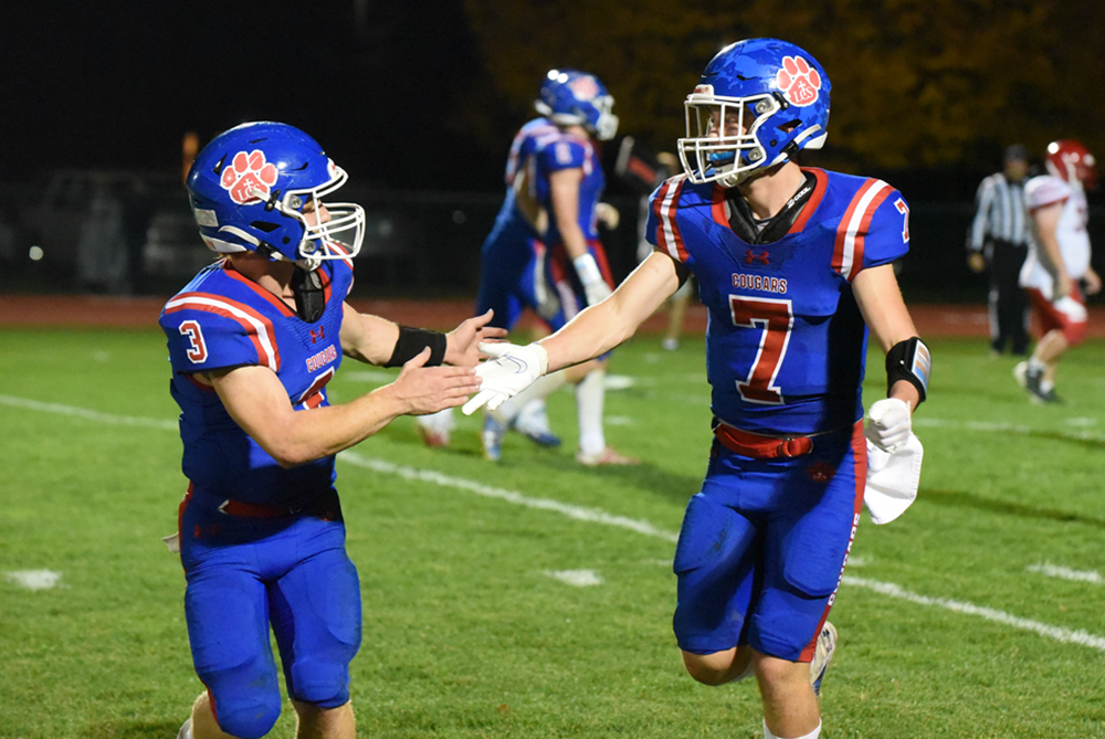 Adrian Lenawee Christian’s Blake Drogowski (7) and Sam Lutz enjoy a moment during a game this season.