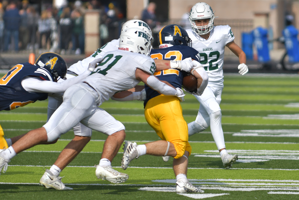 Grand Rapids Forest Hills Central defenders converge during a Division 3 District Final win over Mount Pleasant.