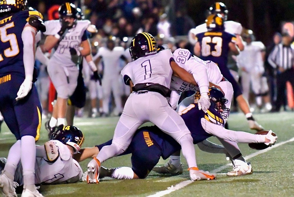 Haslett defenders bring down a Goodrich ball carrier stretching for extra yardage Friday.
