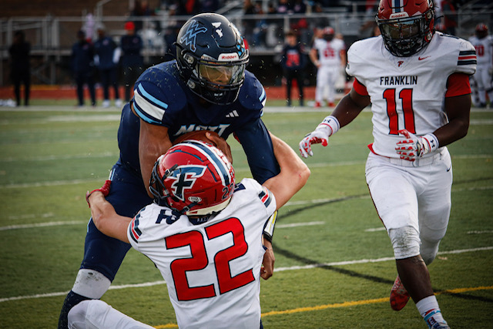 Waterford Mott's Kalieb Osborne takes on a tackler from Livonia Franklin.