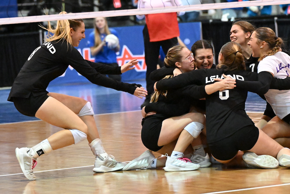 Leland celebrates its five-set win over Crystal Falls Forest Park on Friday at Kellogg Arena.