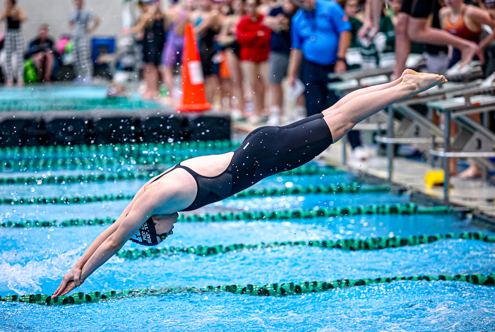 An Ann Arbor Pioneer swimmer launches during Saturday's Lower Peninsula Division 1 Finals at Eastern Michigan University. 