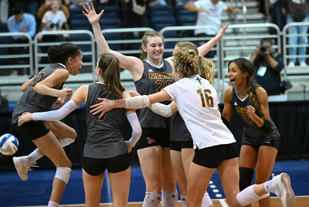 Farmington Hills Mercy surrounds Campbell Flynn (28) in celebration Saturday at Kellogg Arena. 