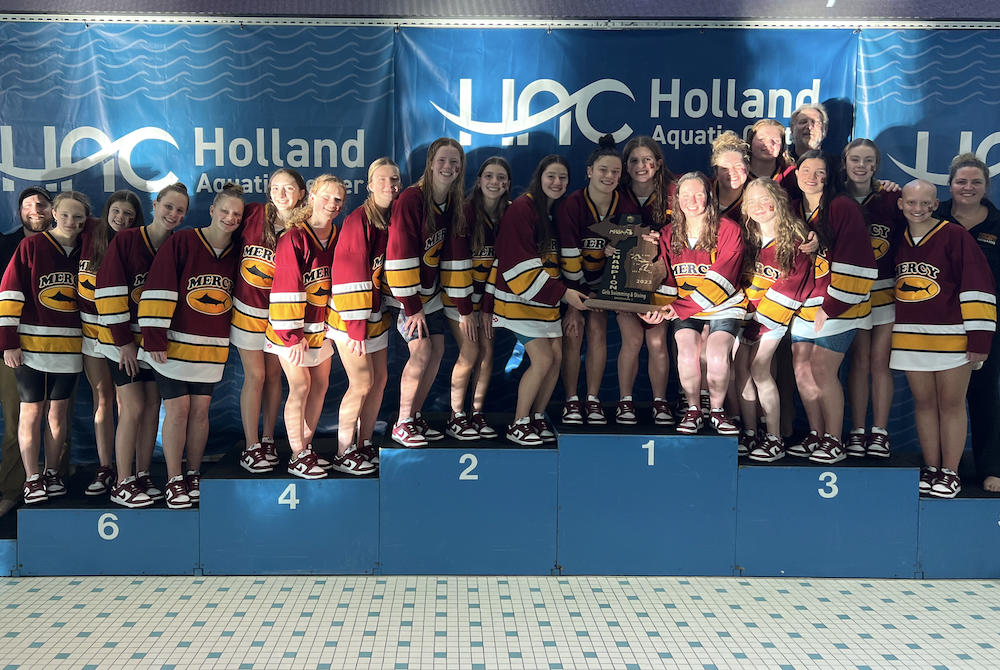 Farmington Hills Mercy celebrates its Division 2 championship at Holland Aquatic Center.