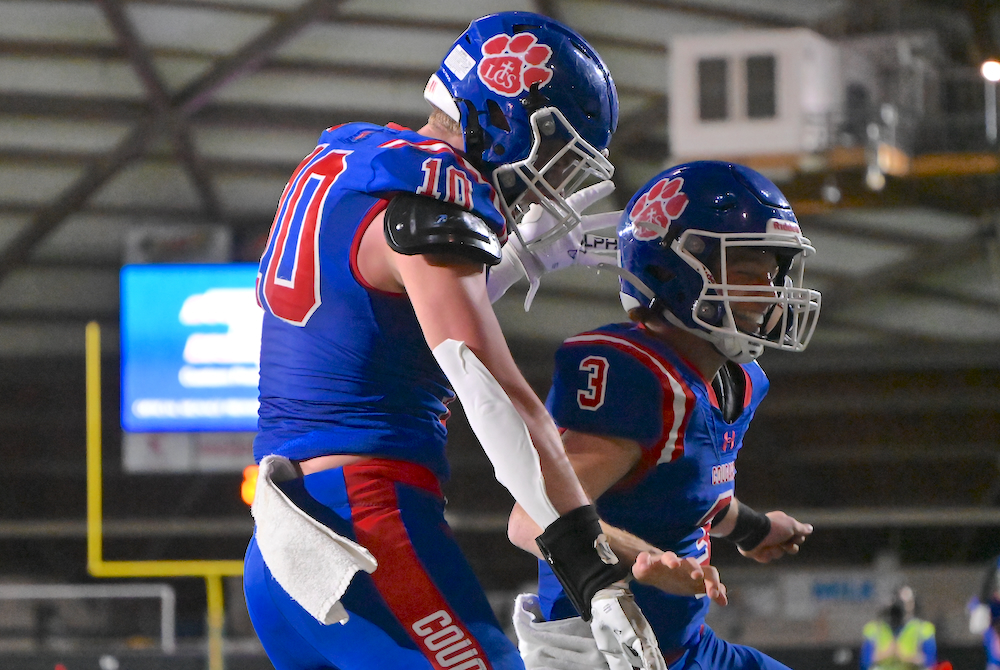 Lenawee Christian’s Easton Boggs (10) and Sam Lutz celebrate a touchdown Saturday at the Superior Dome. 