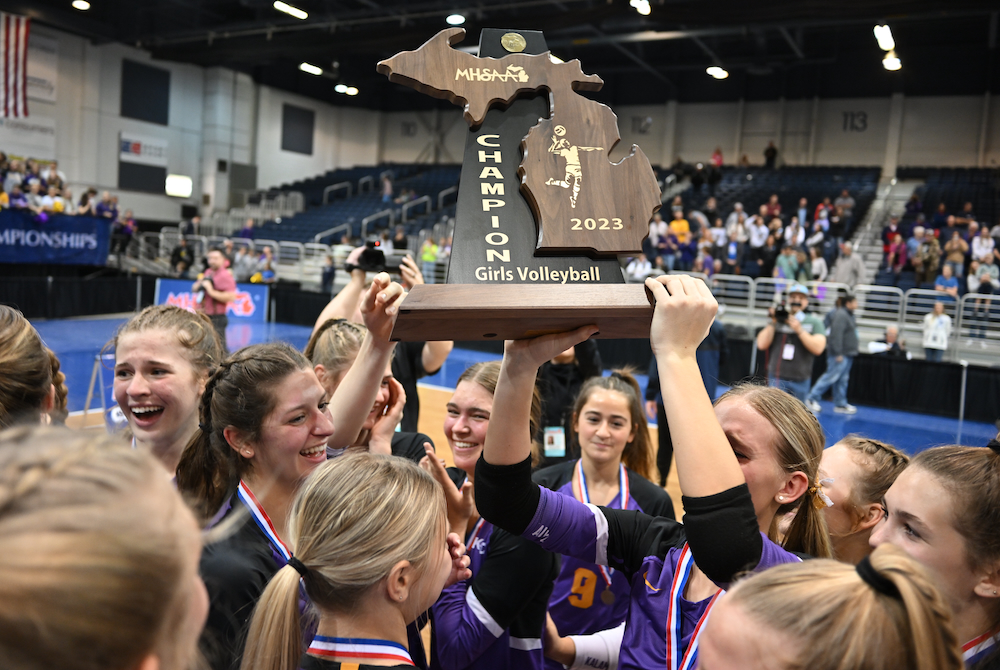 Kalamazoo Christian players hoist their Division 3 championship trophy Saturday at Kellogg Arena. 