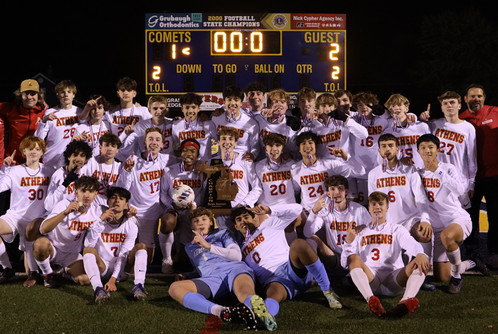 Troy Athens players celebrate their overtime victory Saturday night at Grand Ledge.