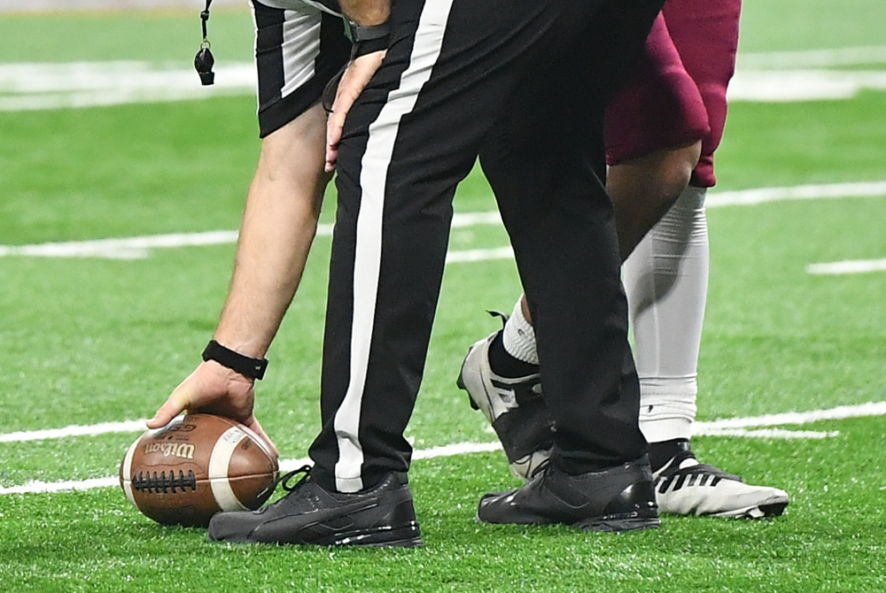 An official places the ball during the Football Finals at Ford Field.