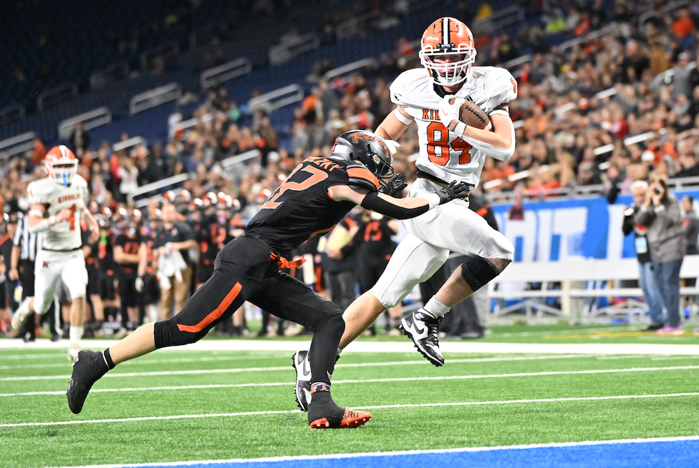 Kingsley’s Chase Bott (84) makes his move toward the goalline while Chase Battani works to wrap him up Saturday at Ford Field.
