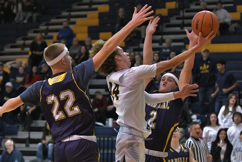 Cadillac works to clog the lane during its 53-38 win over Mount Pleasant.