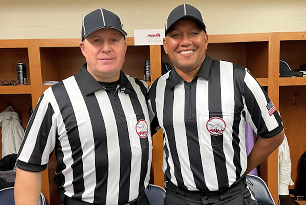 Todd Gooding, left and Rob King take a photo together while officiating the Division 4 Final at Ford Field in 2022. 