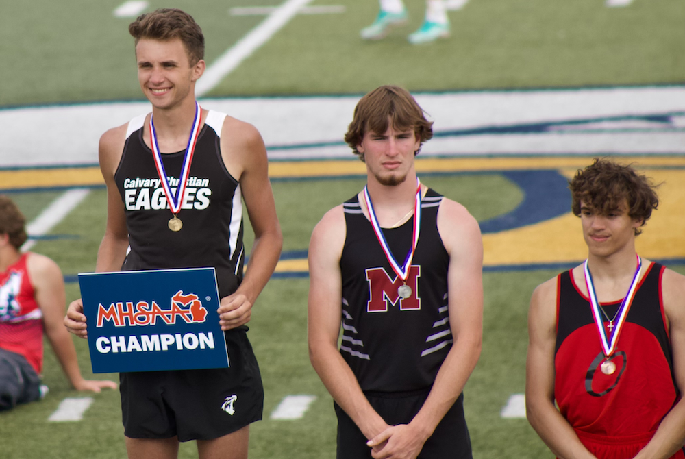 Fruitport Calvary Christian’s Bradley Richards stands atop the podium after winning the high jump last spring at the Lower Peninsula Division 4 Finals. 