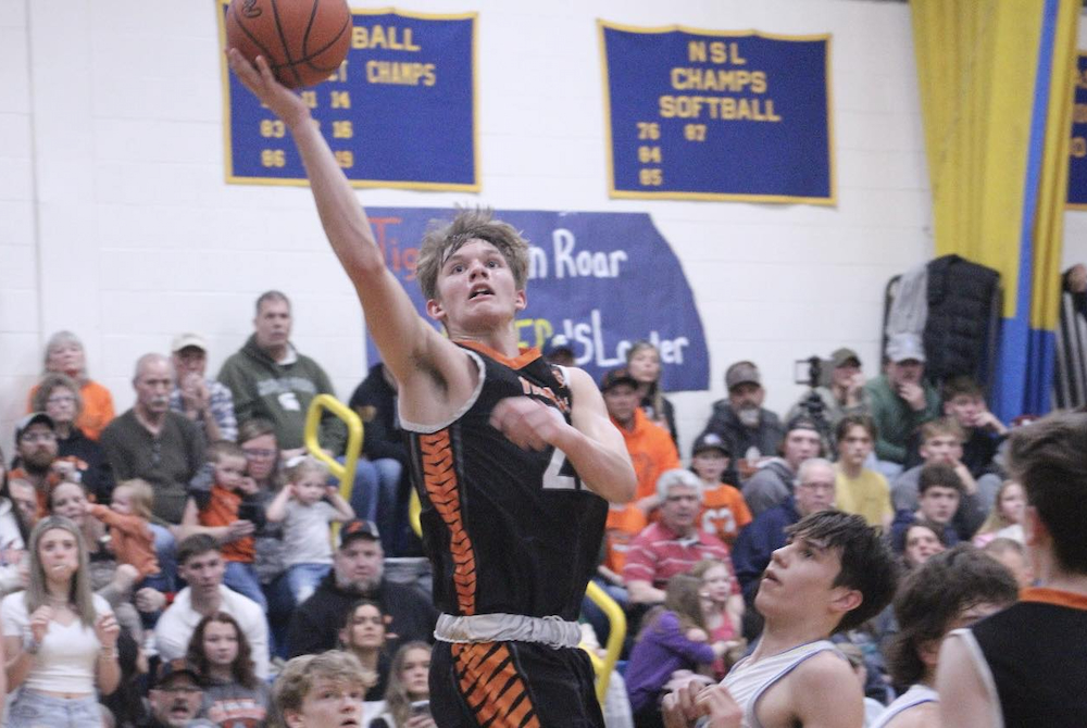 Hillman’s Trenton Taratuta (22) gets to the basket as the crowd anticipates two points.