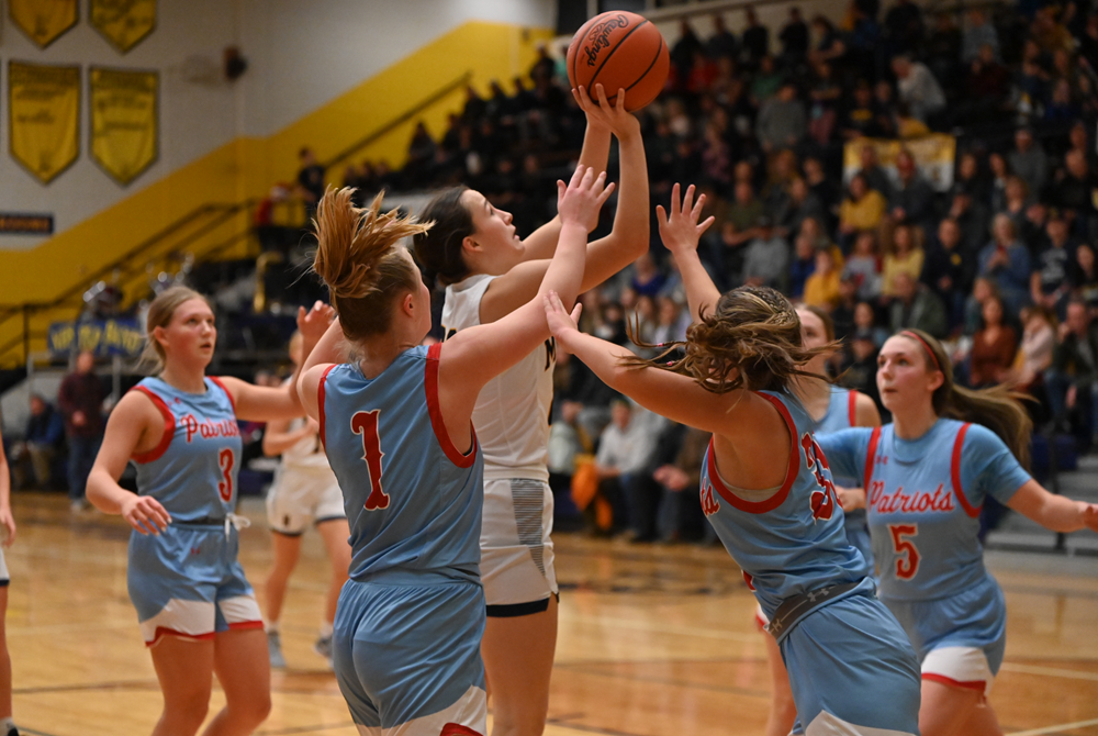 Negaunee's Keira Waterman goes up for a shot while being defended by Ishpeming Westwood's Makayla Fisher (1) and Kaylin Doney (30) during a Dec. 21 win.