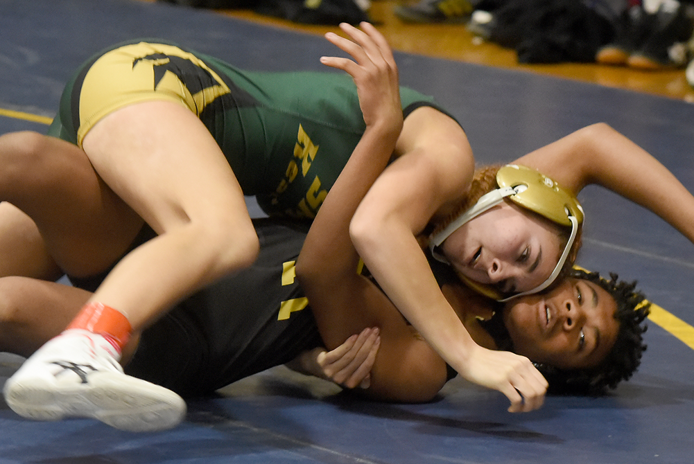 Monroe St. Mary’s MaryAlice Lynch, in green, works to gain control during a match.