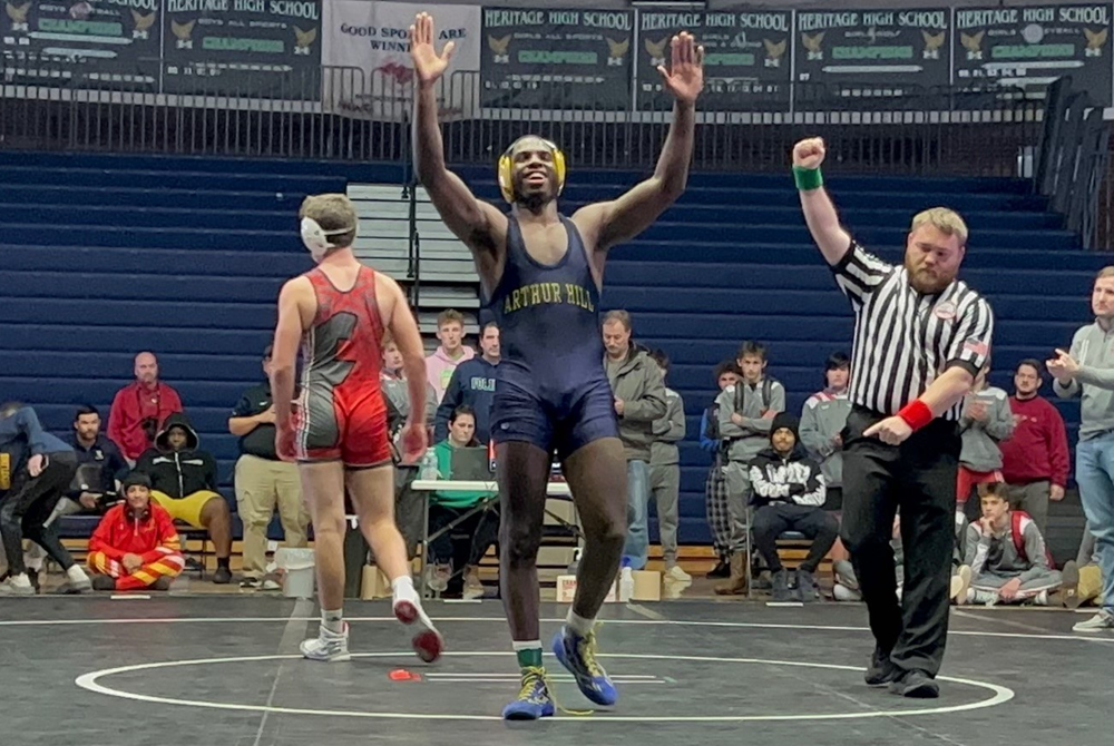 Arthur Hill's Michael Baldwin celebrates his championship win at Saginaw Heritage.