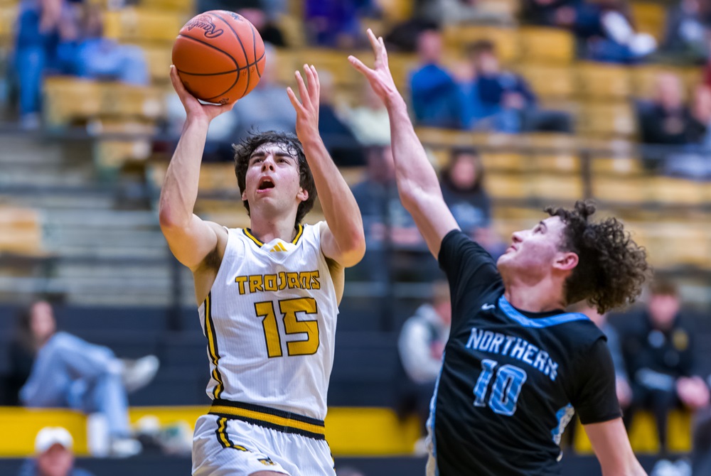 Traverse City Central’s Anthony Ribel, left, gets to the basket during his first game this season, against Grand Rapids Forest Hills Northern on Jan. 2.
