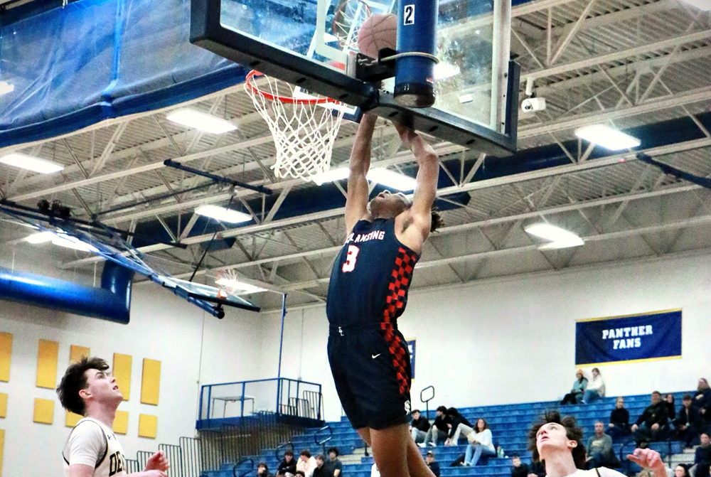 Jayce Branson (3) gets to the rim during East Lansing's 52-29 win over DeWitt last week. 