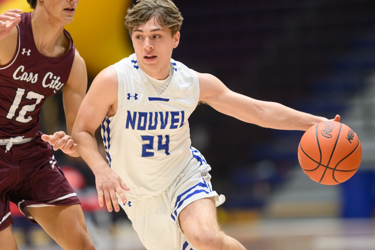 Nouvel Catholic Central senior guard MJ Yeager drives past a defender during a game against Cass City at the O'Neal Classic Tournament on Dec. 2 at Saginaw Valley State University. 