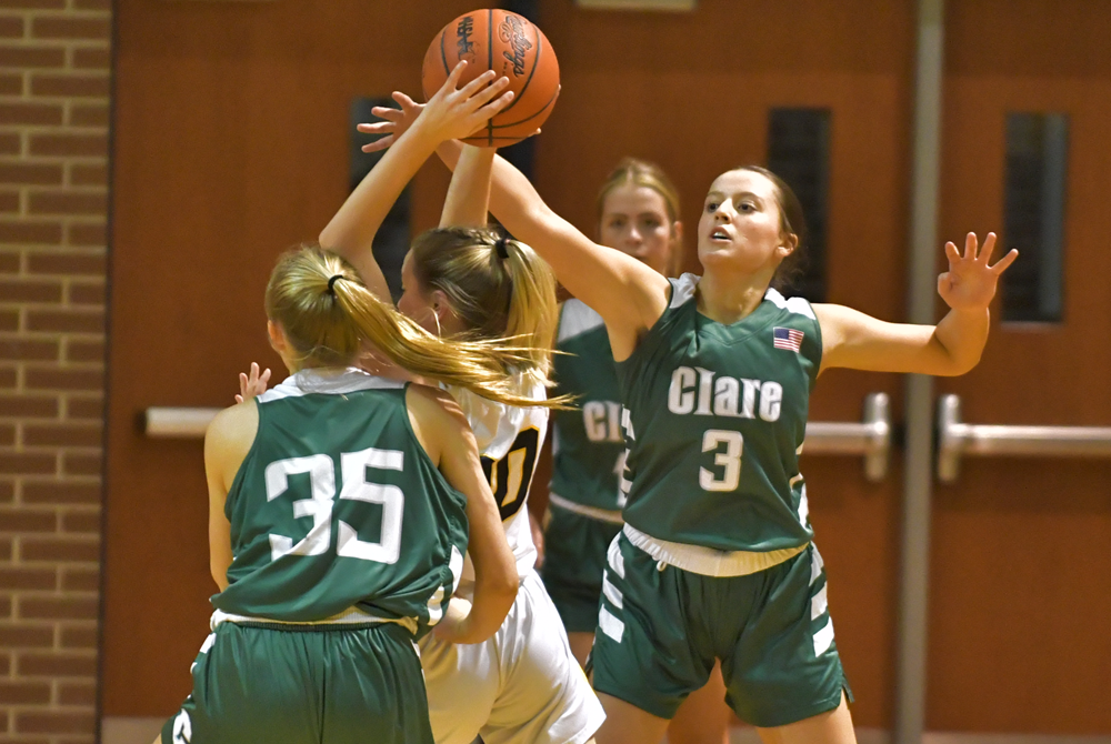 Clare defenders surround a Shepherd player heading toward the basket during last week's 46-21 win over the Bluejays. 