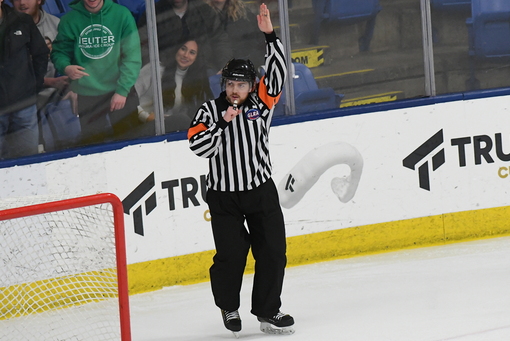 A hockey official signals during the 2022 Semifinals. 