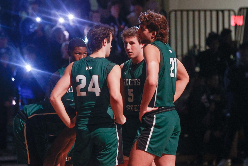 Muskegon Reeths-Puffer’s starters including Travis Ambrose (21) and Jaxson Whitaker (5) huddle before the start of Friday’s win over Mona Shores.