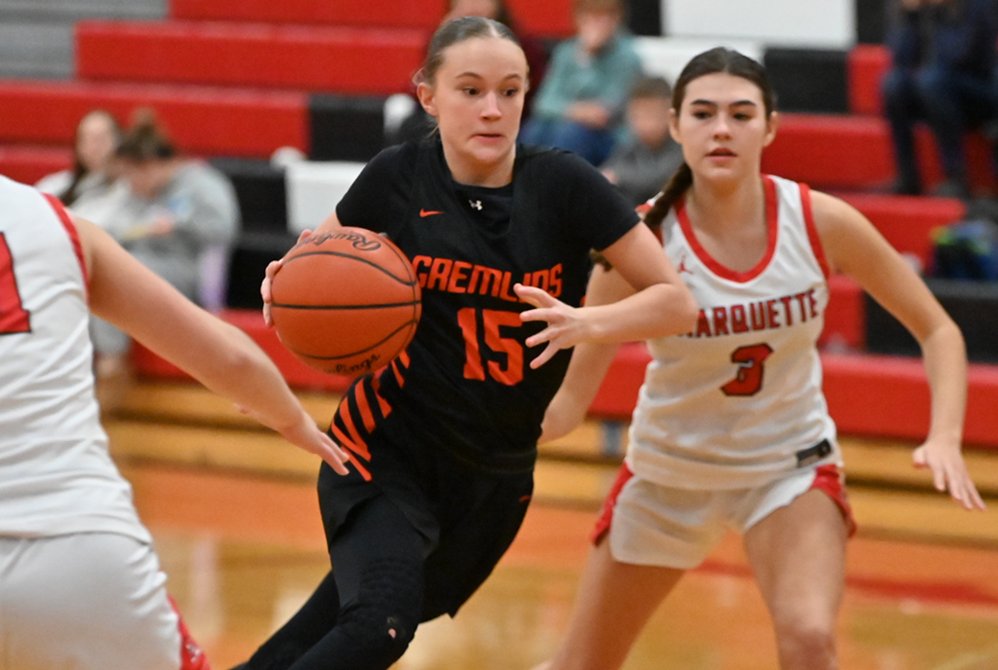 Houghton's Jacey Sleeman drives between Marquette's Lexi Curran and Lexi L'Huillier (3) during Marquette's 48-41 win Feb. 5. 