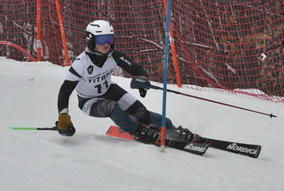 Traverse City West's Caleb Lewandowski races around a gate.