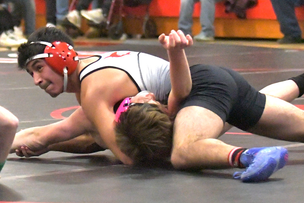 St. Louis works toward a pin during a match against Chesaning this season.