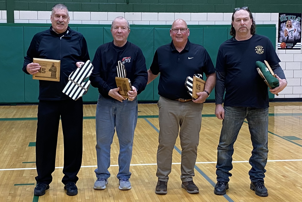 rom left: MHSAA-registered officials Curt Lowe, Joel Venia and Jerry Sauder and Brown City statistician Todd Vandewarker stand together as they are celebrated Thursday at Brown City. 
