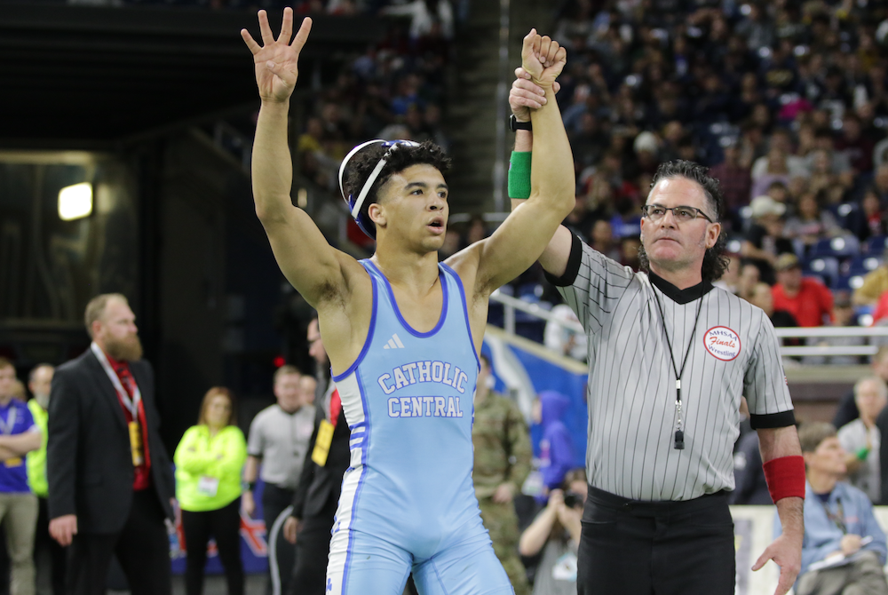 Detroit Catholic Central’s Darius Marines has his wrist raised in victory after clinching his fourth Individual Finals championship Saturday. 