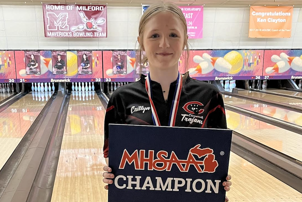 Clarenceville's Caitlyn Johnson holds up her champion's sign Saturday.