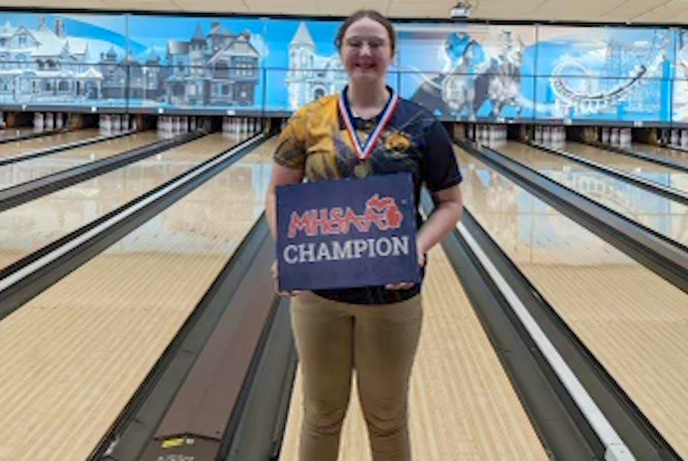 Bad Axe's Jasmyn Ranquist stands for a photo with her championship sign. 