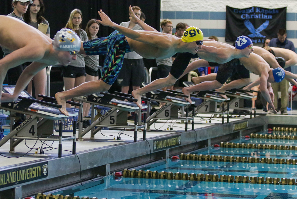 Adrian’s London Rising, East Grand Rapids’ Carter Kegle and Cranbrook’s Will Farner are among those launching to start last season’s 200 freestyle championship race during the LP Division 3 Finals at Oakland University.
