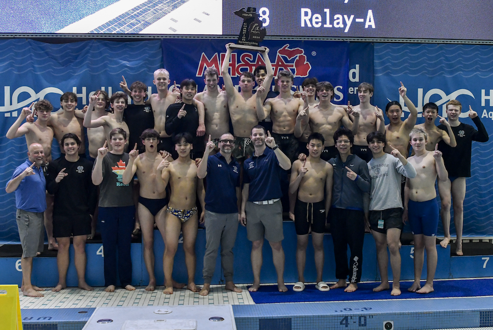 Cranbrook Kingswood celebrates its victory Saturday at Holland Aquatic Center.