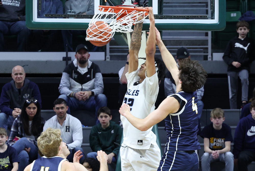 Grand Rapids Christian’s DeClan Winstanley (22) dunks before Chelsea’s Hayden Long (4) can get a hand in to stop the attempt. 
