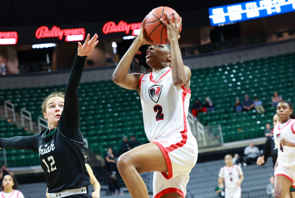 Detroit Edison’s Isis Johnson-Musah gets to the basket Saturday with FGR’s Bethie Benz (12) defending.