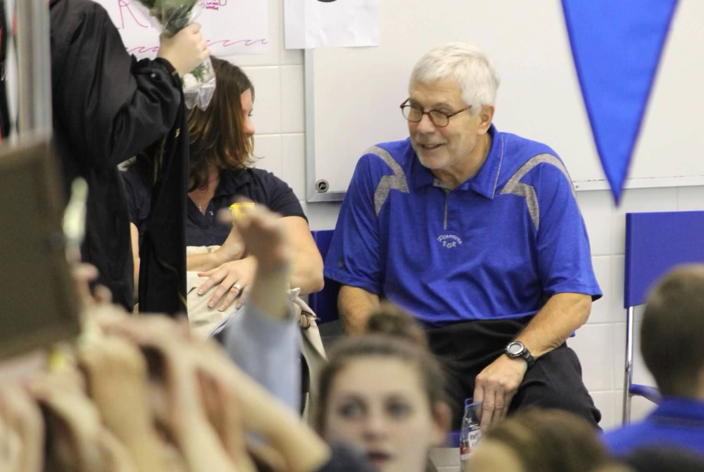 Longtime East Grand Rapids swimming coach Butch Briggs, right, will be celebrated this weekend for his half-century of coaching the Pioneers. 