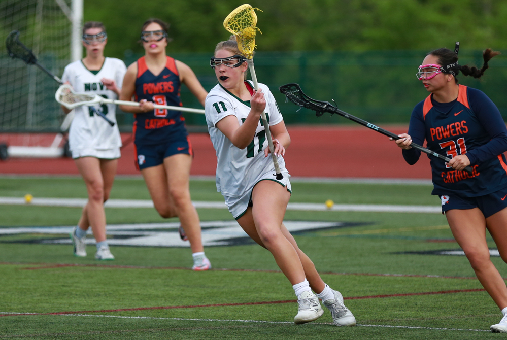 Novi's Ally Katinas brings the ball upfield against Flint Powers Catholic.