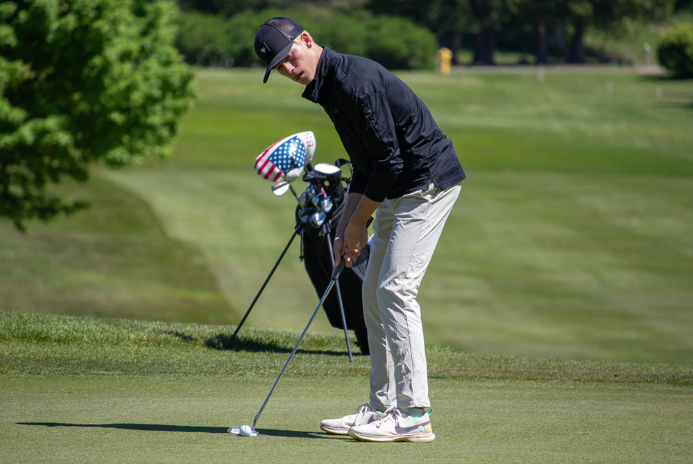 Marquette's Kaleb Chipelewski addresses his putt on the ninth hole during the MHSAA Upper Peninsula Division 1 Final on Wednesday at Marquette Golf Club. 