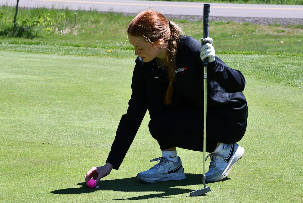 Escanaba’s Lilly VanDamme lines up a putt during the Upper Peninsula Division 1 Final at Wawonowin Country Club. 