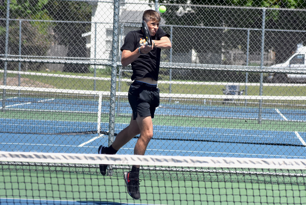 Munising's Carson Kienitz returns a serve during the No. 1 singles championship match at the MHSAA U.P. Division 2 Final on Wednesday in Kingsford.