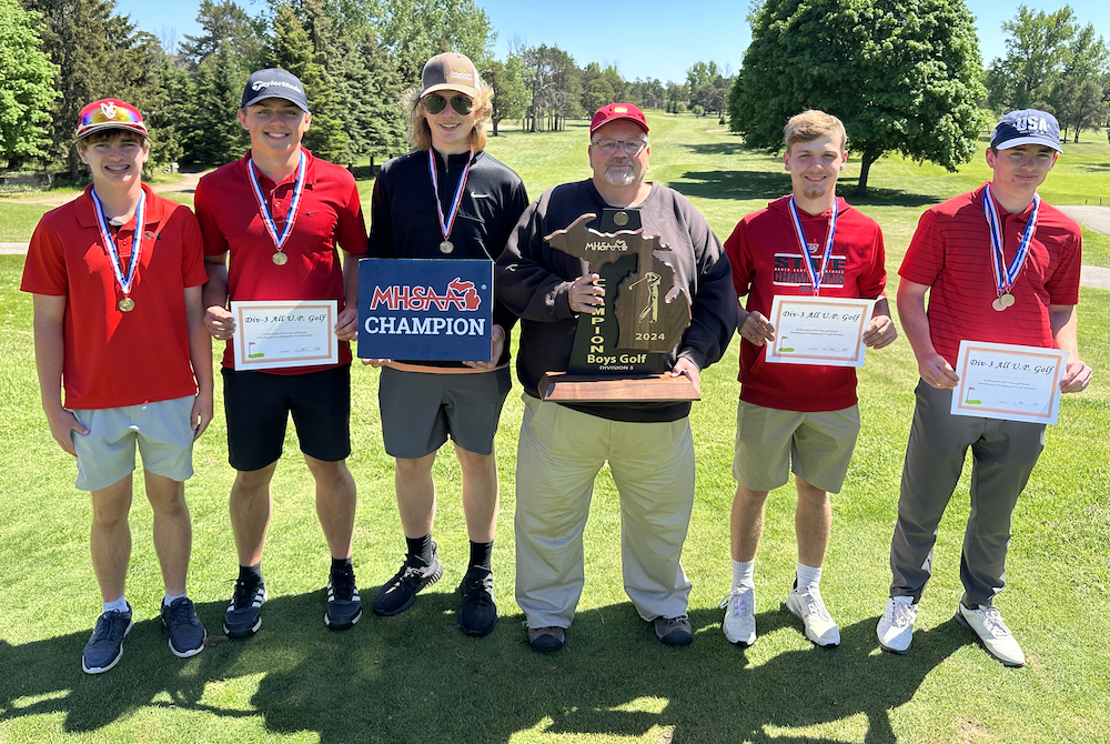 Powers North Central holds up its latest championship trophy Wednesday at Escanaba Country Club. 