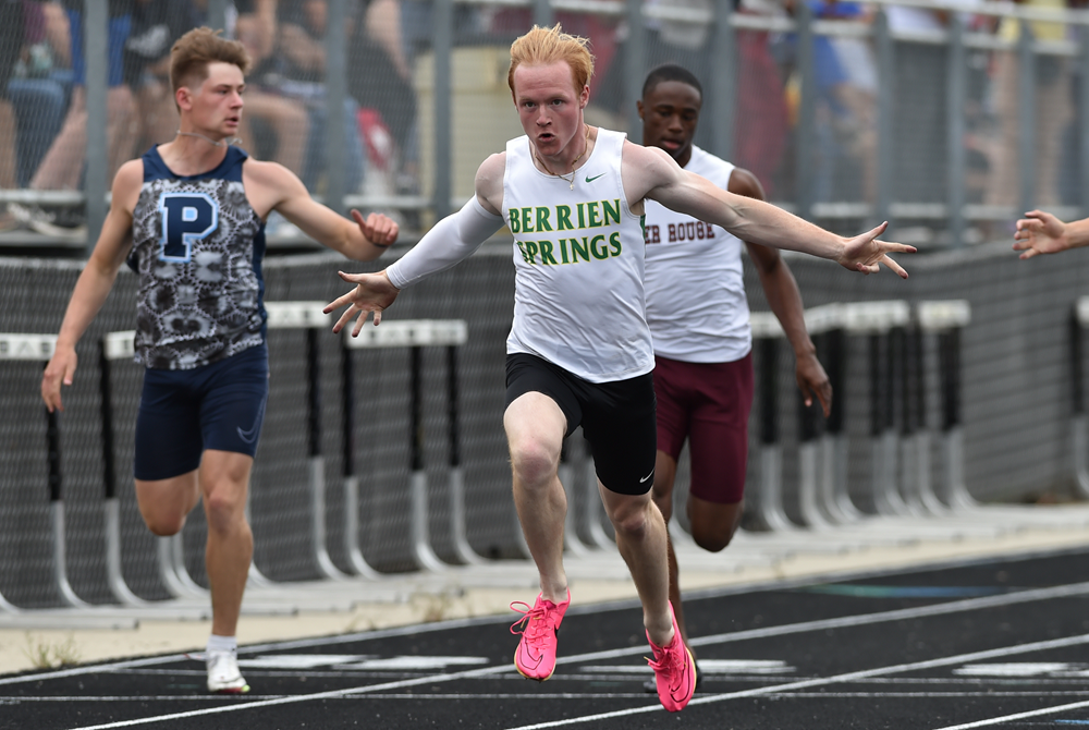 Berrien Springs’ Jake Machiniak, second from left, crosses the finish line first in the 100 during the Lower Peninsula Division 2 Finals on Saturday. 