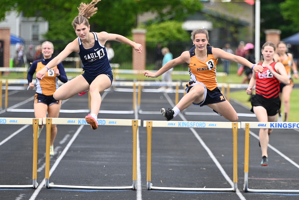 Sault Ste. Marie's Ahnaka Oshelski, left, edges Negaunee's Sadie Rogers by one hundredth of a second to capture the 300 hurdles title Saturday. 