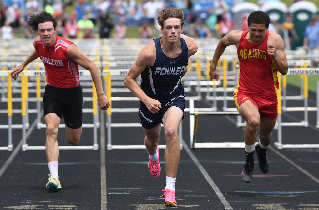 Fowler’s Brady Feldpausch, left, edges Reading’s Tayshawn Bester to win the 110 hurdles Saturday at Baldwin Middle School. 